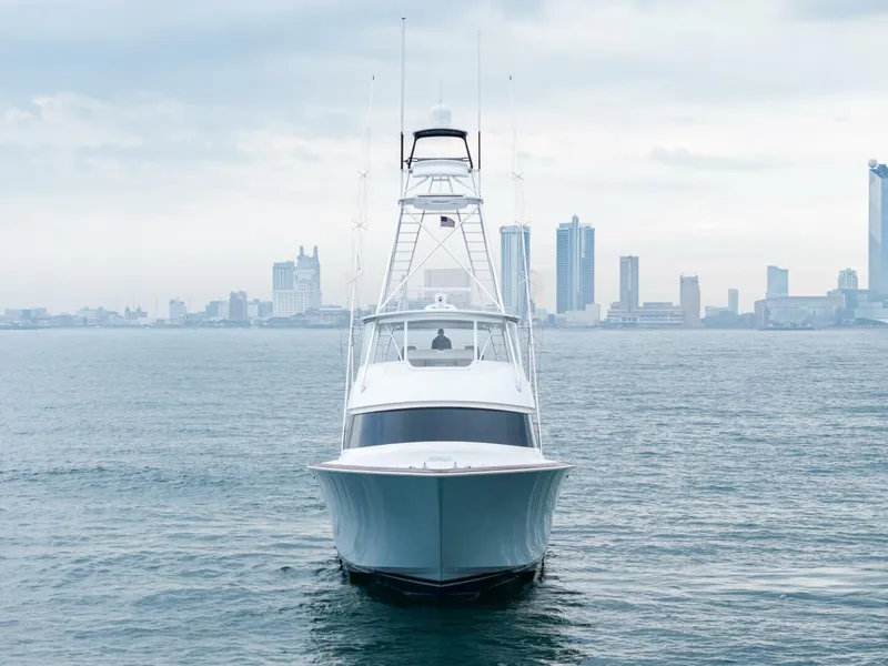 Slide: The Image of 2025 Viking 82 Convertible yacht on water with city skyline in background. - 48