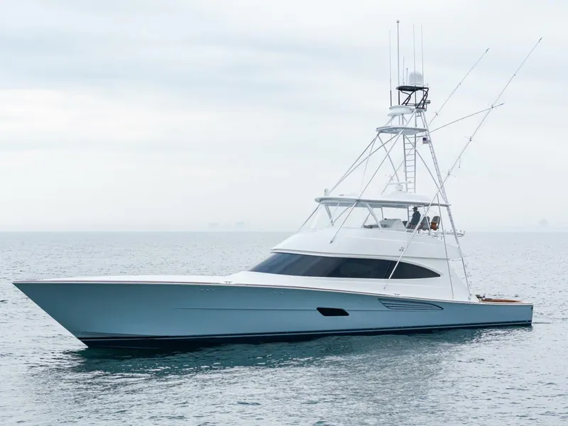 Slide: The Image of 2025 Viking 82 Convertible yacht on calm sea under cloudy sky. - 49
