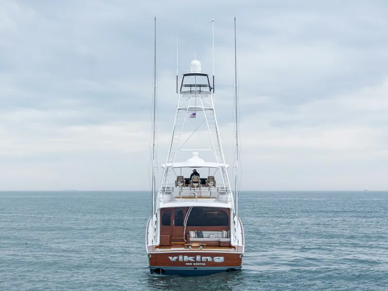 Slide: The Image of 2025 Viking 82 Convertible yacht on open sea, rear view. - 6