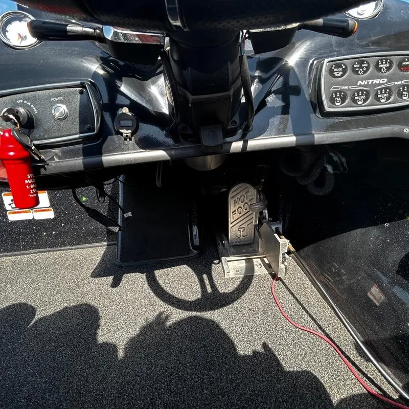 Slide: The Image of Dashboard and controls of a 2019 Nitro Z20 Pro boat with foot pedal and fire extinguisher. - 19