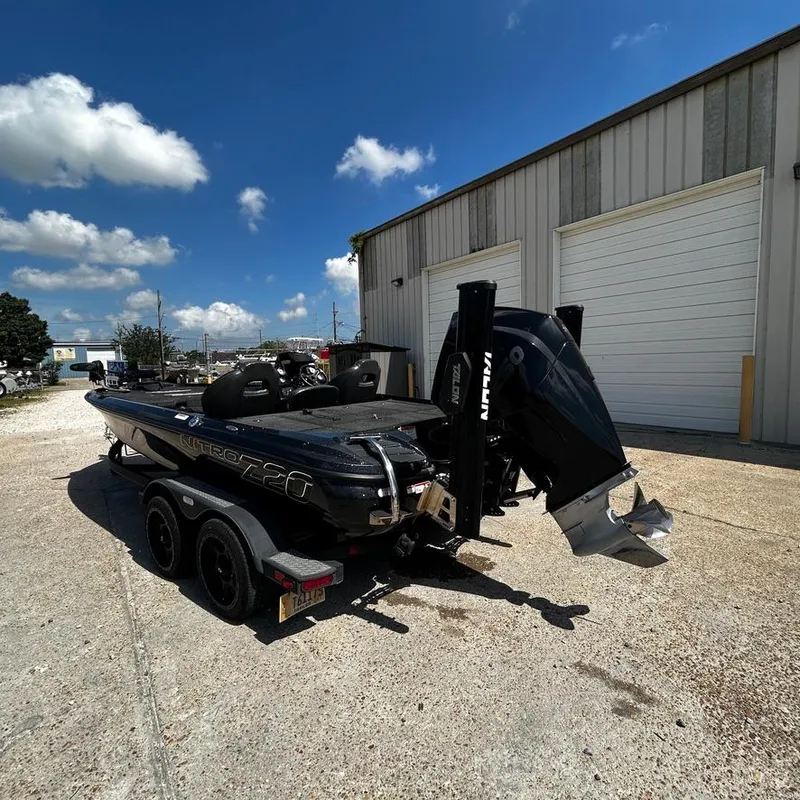 Slide: The Image of 2019 Nitro Z20 Pro boat on trailer outside a garage under a clear blue sky. - 4