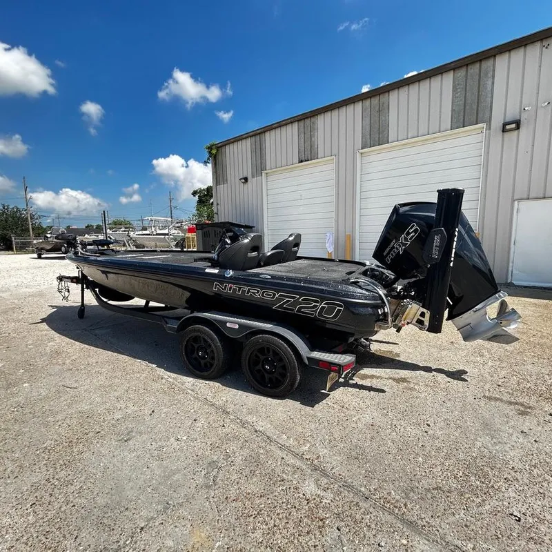Slide: The Image of 2019 Nitro Z20 Pro boat on a trailer outside a garage under a clear blue sky. - 5