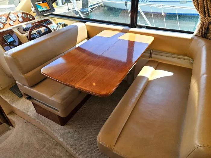 Slide: The Image of Interior of 2007 Meridian 411 Sedan yacht with leather seating and wooden table. - 12