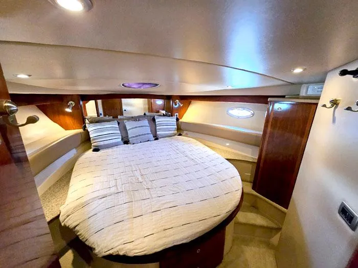 Slide: The Image of Luxurious cabin interior of 2007 Meridian 411 Sedan yacht with cozy bed and ambient lighting. - 14