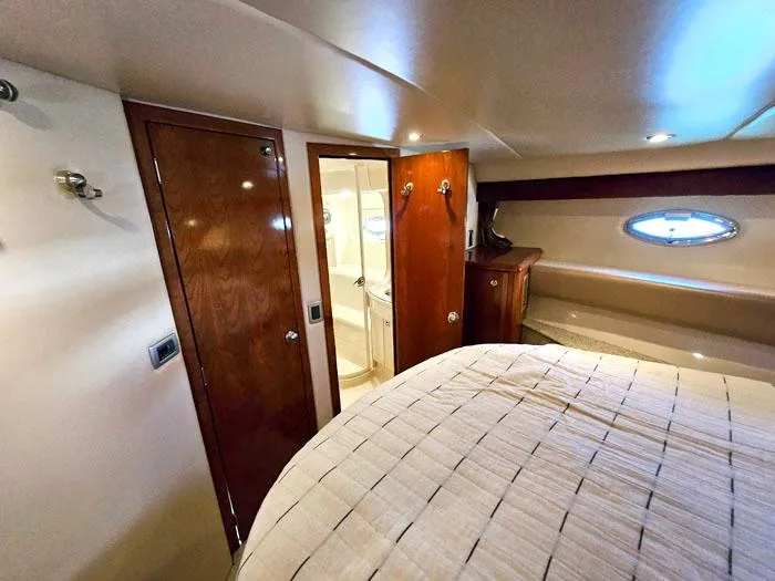 Slide: The Image of Luxurious cabin interior of 2007 Meridian 411 Sedan yacht with wood finishes and porthole. - 15