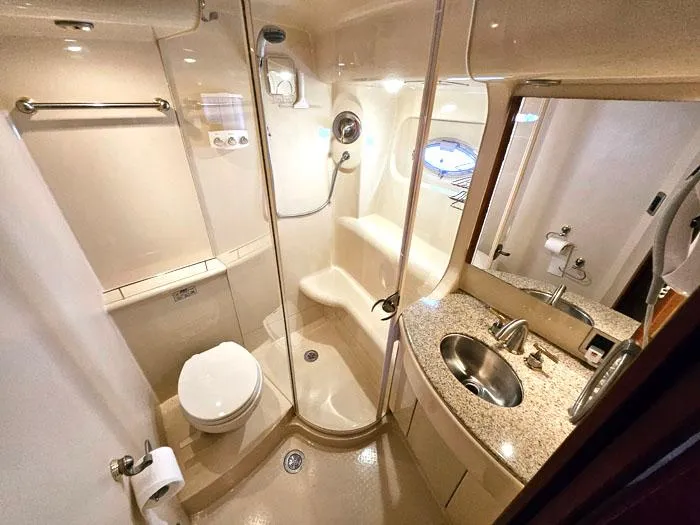 Slide: The Image of Luxurious bathroom in 2007 Meridian 411 Sedan yacht with shower, sink, and toilet. - 16