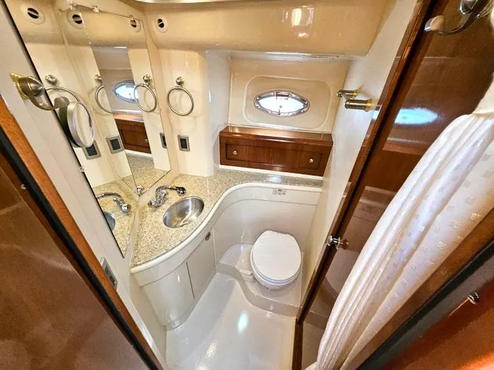 Slide: The Image of Luxurious bathroom in 2007 Meridian 411 Sedan yacht with modern fixtures and porthole window. - 18