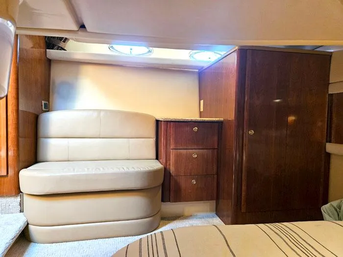 Slide: The Image of Interior of 2007 Meridian 411 Sedan yacht with leather seating and wooden cabinetry. - 19