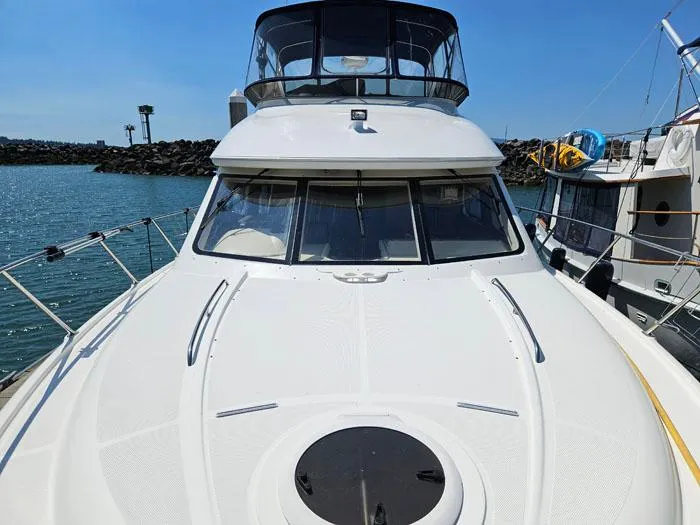Slide: The Image of 2007 Meridian 411 Sedan yacht docked at marina, showcasing sleek design and spacious deck. - 20