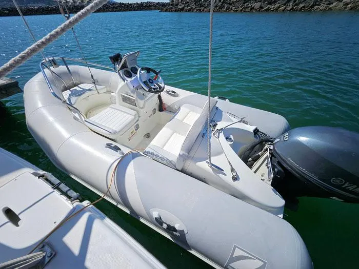 Slide: The Image of Inflatable boat docked on water, featuring a Yamaha outboard motor. - 26