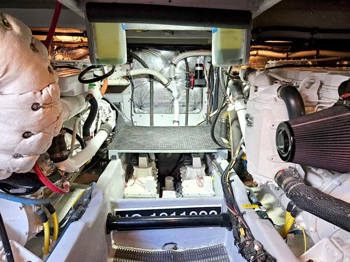 Slide: The Image of Engine room of a 2007 Meridian 411 Sedan yacht, showcasing mechanical components and wiring. - 28