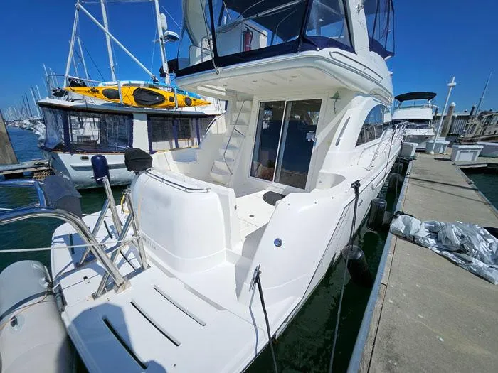 Slide: The Image of 2007 Meridian 411 Sedan yacht docked at marina under clear blue sky. - 3