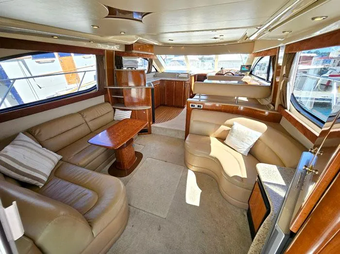 Slide: The Image of Luxurious interior of a 2007 Meridian 411 Sedan yacht with plush seating and elegant wood finishes. - 5