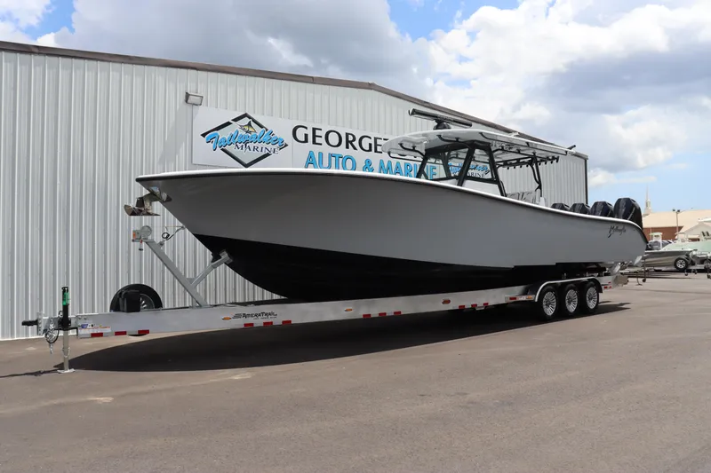 Slide: The Image of 2024 Yellowfin 39 Offshore boat on a trailer outside George's Auto & Marine. - 1