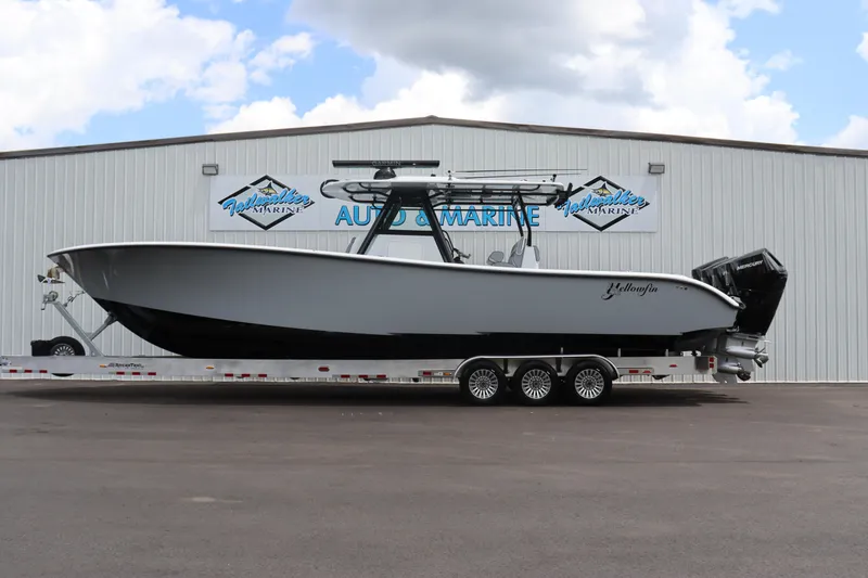 Slide: The Image of 2024 Yellowfin 39 Offshore boat on a trailer outside a marine dealership. - 12