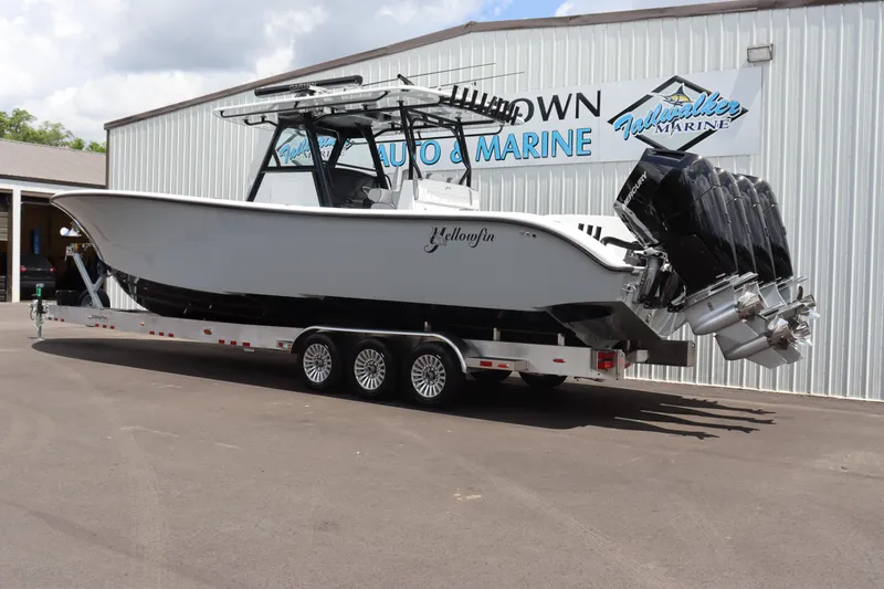 Slide: The Image of 2024 Yellowfin 39 Offshore boat on a trailer outside a marine dealership. - 2