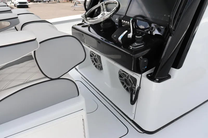 Slide: The Image of 2024 Yellowfin 39 Offshore boat cockpit with steering wheel and control panel. - 24