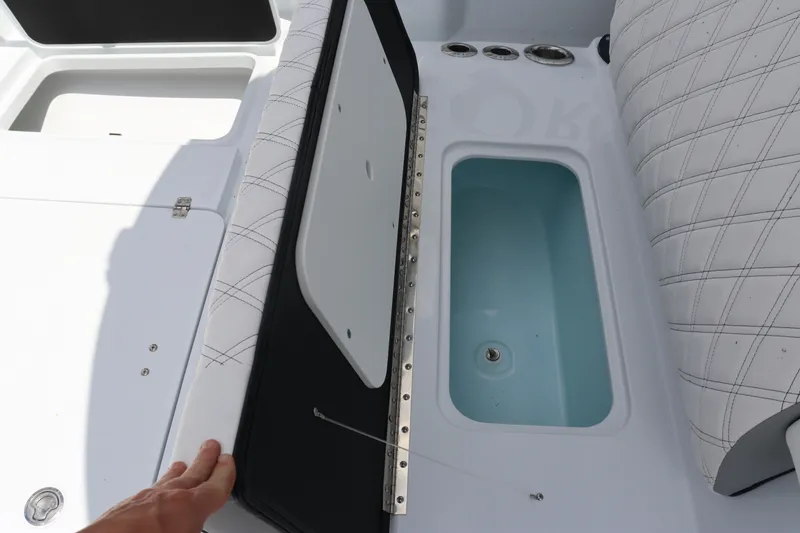 Slide: The Image of 2024 Yellowfin 39 Offshore boat with open storage compartment and cushioned seating. - 33