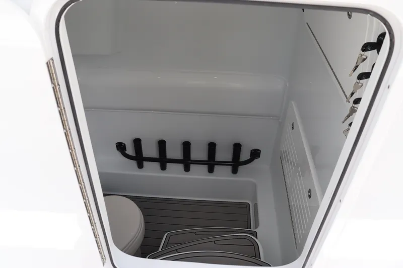 Slide: The Image of 2024 Yellowfin 39 Offshore boat interior storage compartment with rod holders and flooring. - 35