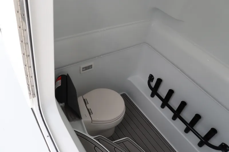 Slide: The Image of 2024 Yellowfin 39 Offshore boat interior with toilet and rod holders. - 36