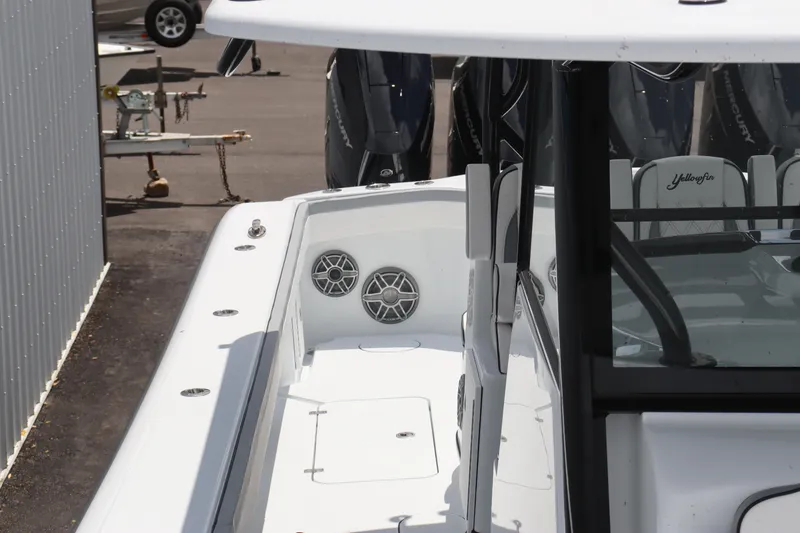 Slide: The Image of 2024 Yellowfin 39 Offshore boat deck with speakers and storage compartments. - 8