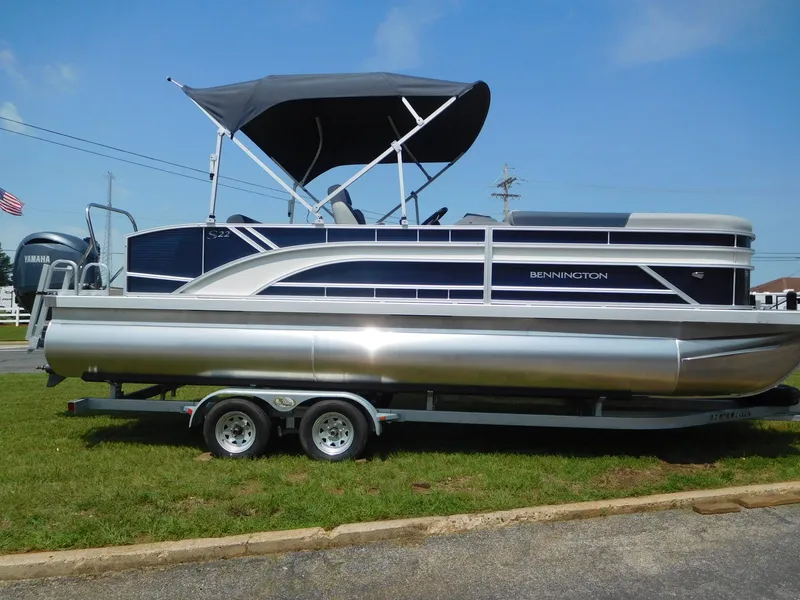 Slide: The Image of 2024 Bennington 22 SSB pontoon boat on a trailer with a canopy. - 1