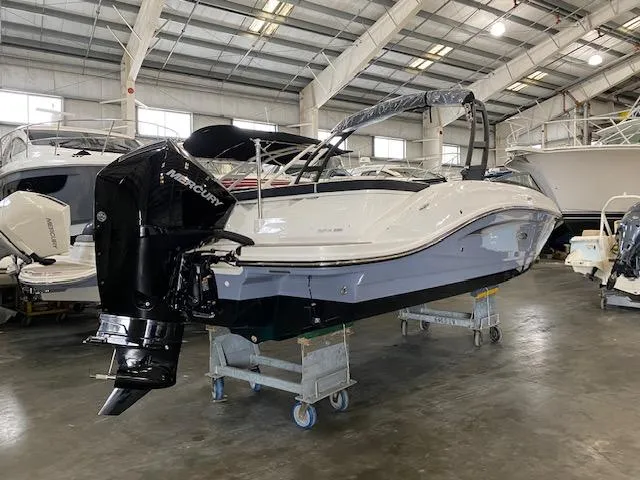 Slide: The Image of 2024 Sea Ray SPX 230 Outboard boat in a showroom. - 1