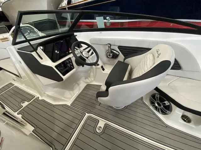 Slide: The Image of 2024 Sea Ray SPX 230 Outboard boat interior with helm, steering wheel, and captain's chair. - 11