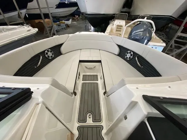 Slide: The Image of 2024 Sea Ray SPX 230 Outboard boat interior with cushioned seating and speakers. - 13