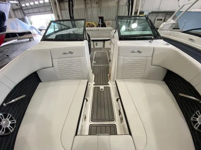 Slide: The Image of 2024 Sea Ray SPX 230 Outboard boat interior with white seating and black accents. - 14