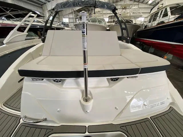 Slide: The Image of 2024 Sea Ray SPX 230 Outboard boat interior, rear seating area in a showroom. - 17