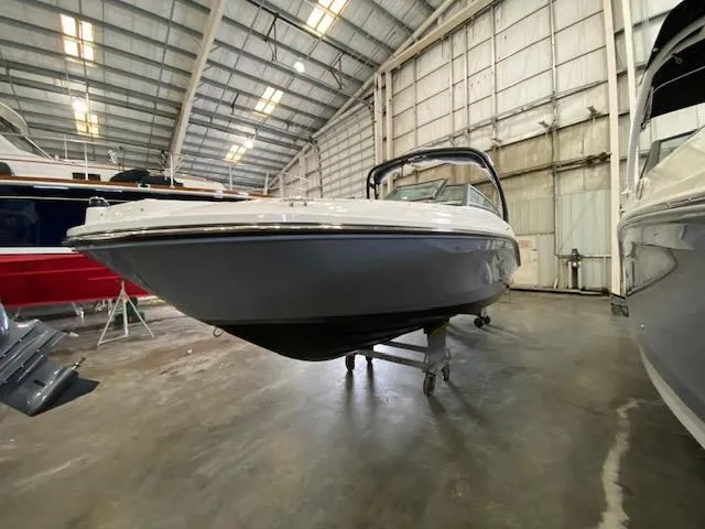 Slide: The Image of 2024 Sea Ray SPX 230 Outboard boat in a storage facility. - 4