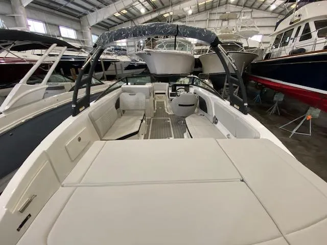 Slide: The Image of 2024 Sea Ray SPX 230 Outboard boat interior in a showroom. - 7