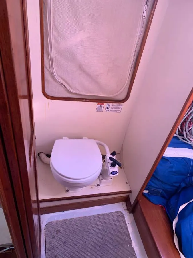 Slide: The Image of Compact marine toilet in a 1991 Tripp 36 sailboat bathroom. - 16