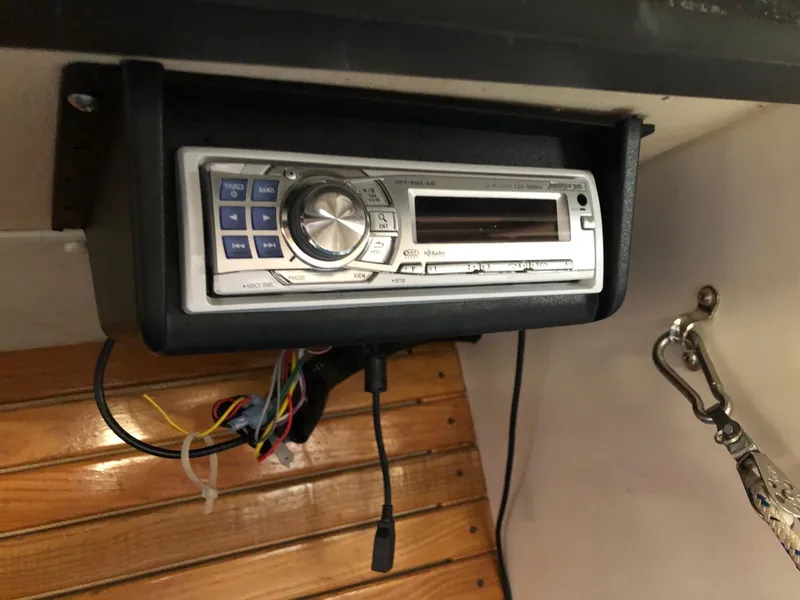 Slide: The Image of 1991 Tripp 36 boat stereo system with exposed wiring and wooden paneling. - 21