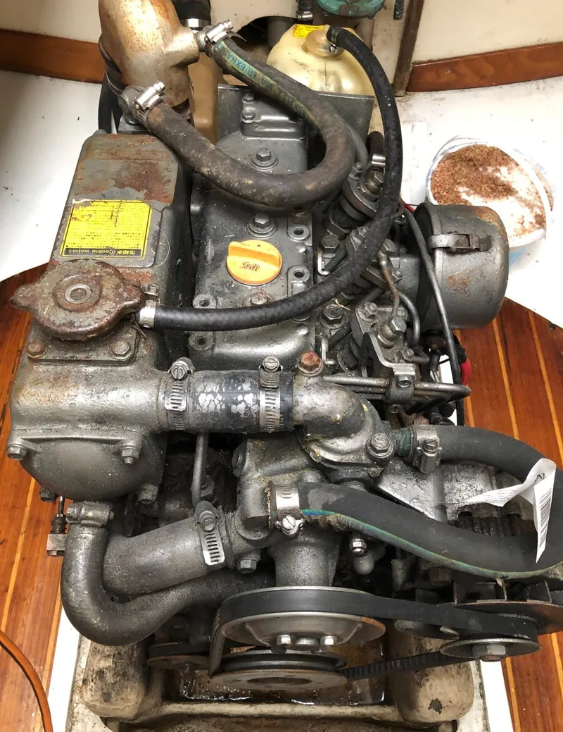 Slide: The Image of Engine of a 1991 Tripp 36 boat, showing hoses and mechanical components. - 24