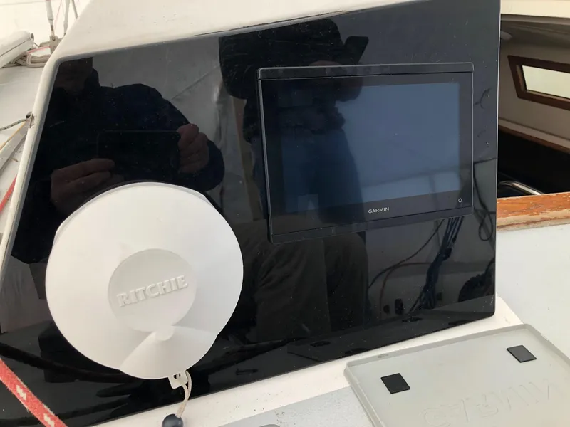 Slide: The Image of Control panel of a 1991 Tripp 36 sailboat with Ritchie compass and display screen. - 25