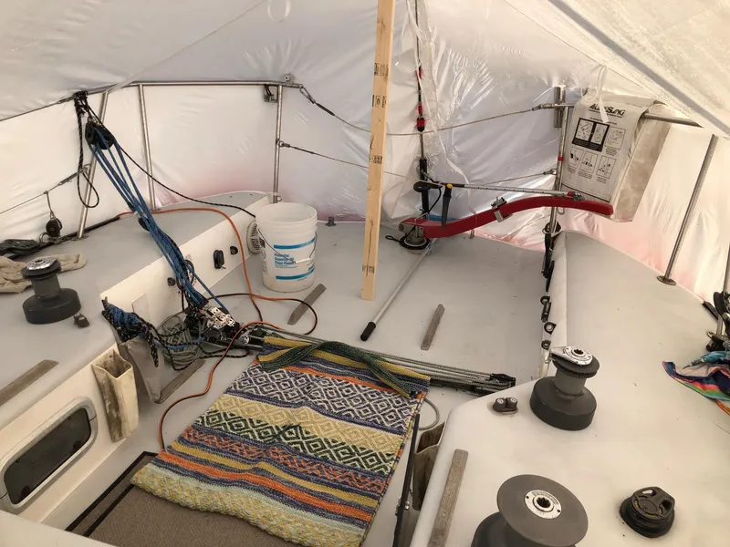 Slide: The Image of Interior of a 1991 Tripp 36 sailboat with colorful rug and sailing equipment. - 27