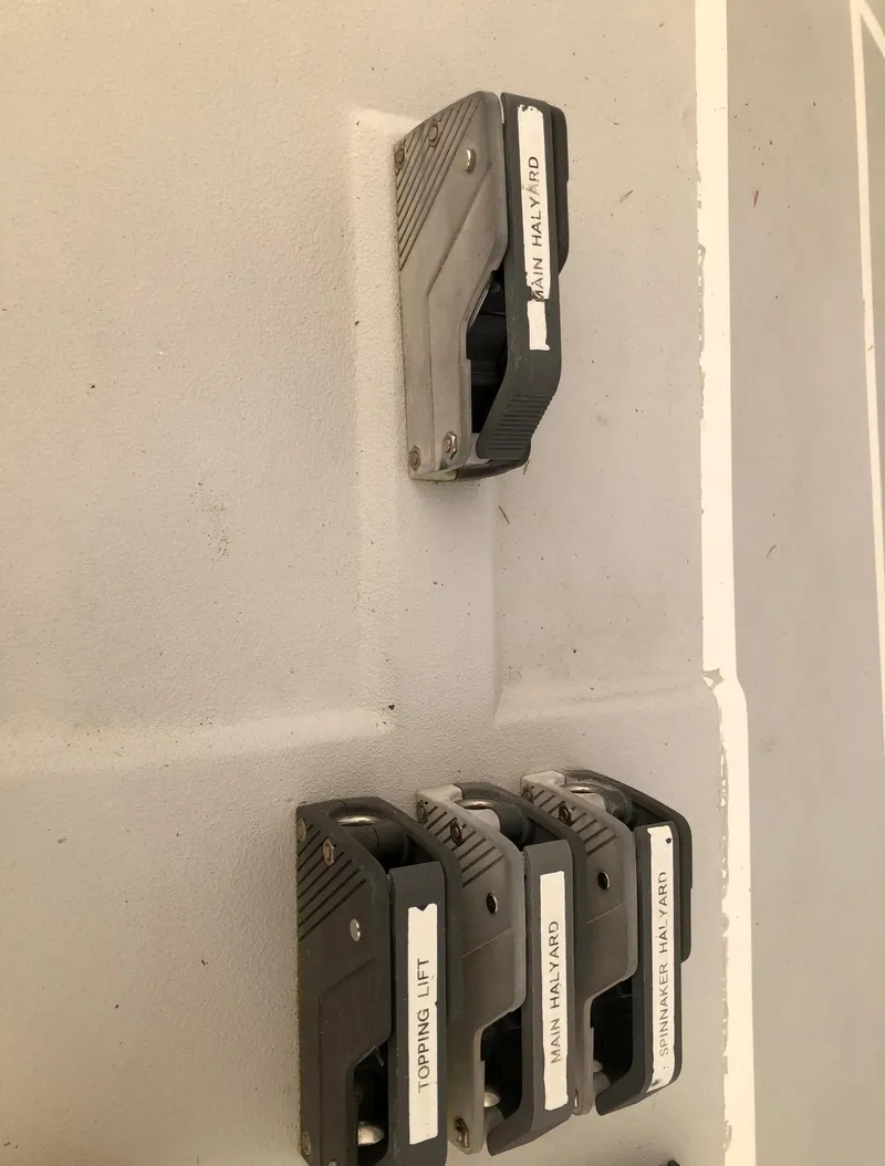 Slide: The Image of Four labeled rope clutches on a Tripp 36 sailboat deck, 1991 model. - 30