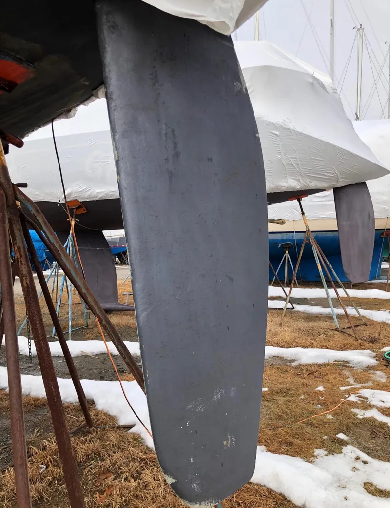 Slide: The Image of Close-up of a 1991 Tripp 36 sailboat keel in a snowy boatyard. - 35