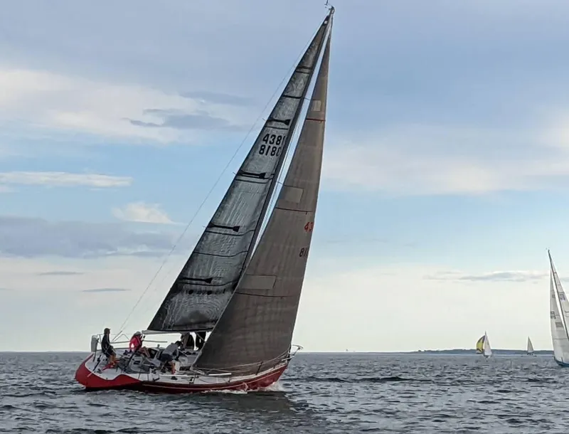 Slide: The Image of Sailing yacht Tripp 36 from 1991 on open water under a clear sky. - 7