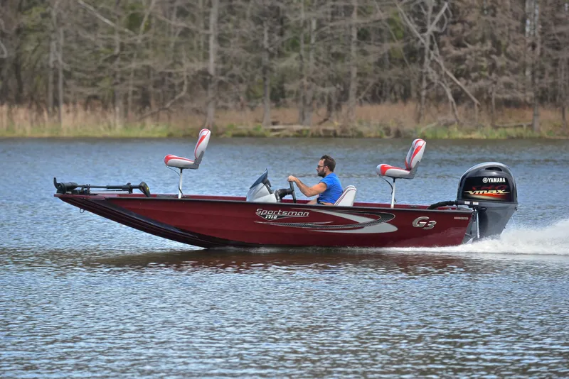 Slide: The Image of 2019 G3 Sportsman 1710 boat cruising on a lake with a Yamaha VMAX engine. - 2