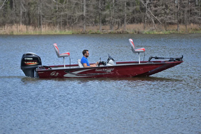Slide: The Image of 2019 G3 Sportsman 1710 boat on a lake with a Yamaha outboard motor. - 7