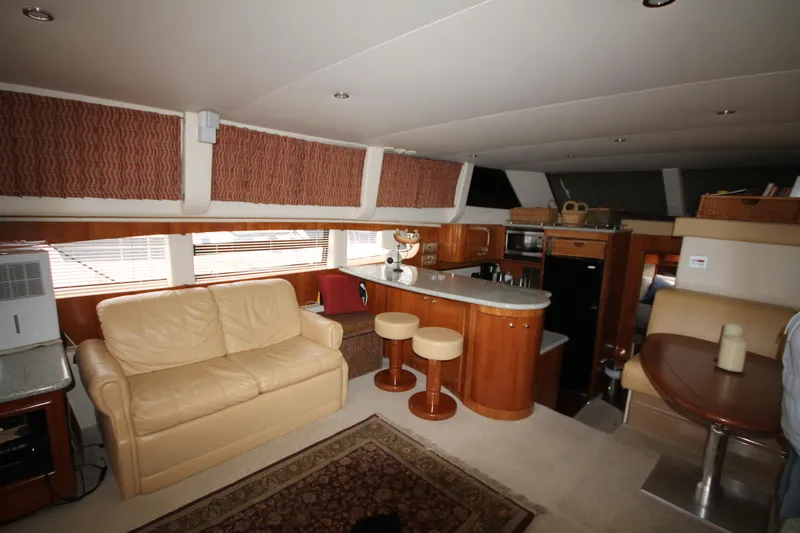 Slide: The Image of Interior of 2001 Carver 466 Motor Yacht with beige leather sofa and modern kitchen. - 10