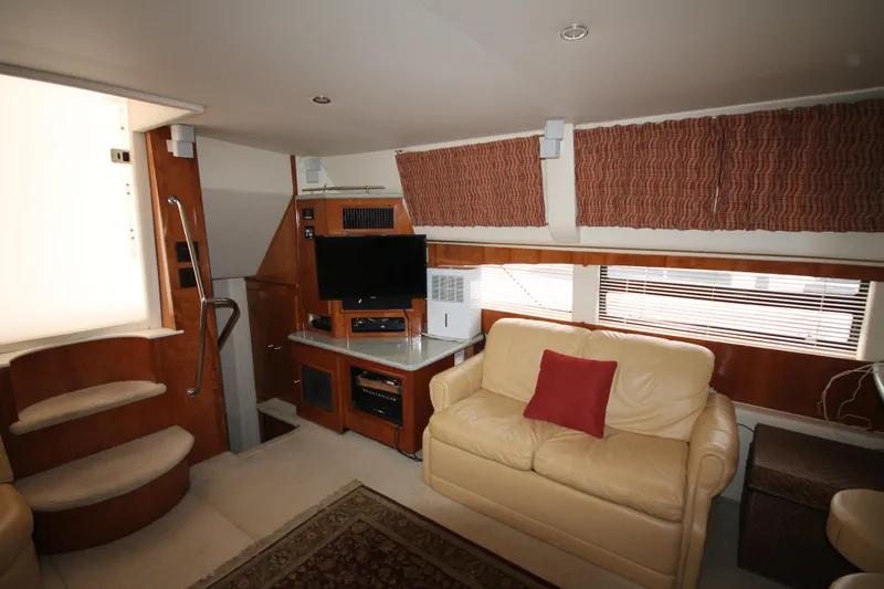 Slide: The Image of Interior of 2001 Carver 466 Motor Yacht with beige leather sofa and entertainment center. - 11