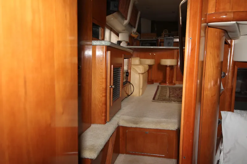 Slide: The Image of Interior of 2001 Carver 466 Motor Yacht with wooden cabinetry and carpeted flooring. - 12