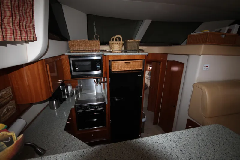 Slide: The Image of 2001 Carver 466 Motor Yacht kitchen with modern appliances and wooden cabinetry. - 14