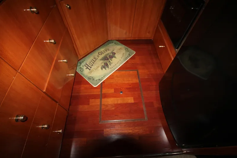 Slide: The Image of Interior of 2001 Carver 466 Motor Yacht with wooden flooring and storage cabinets. - 17