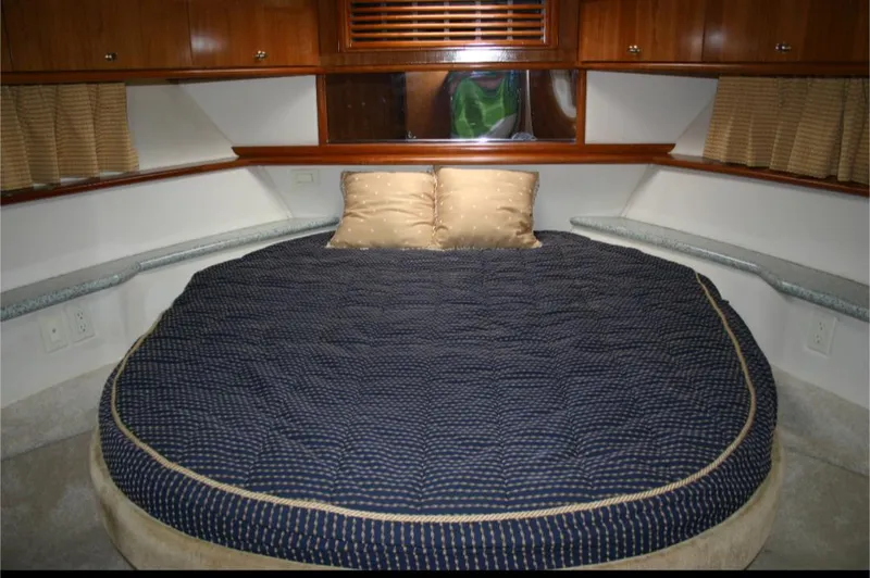 Slide: The Image of 2001 Carver 466 Motor Yacht master bedroom with round bed and wooden cabinetry. - 18