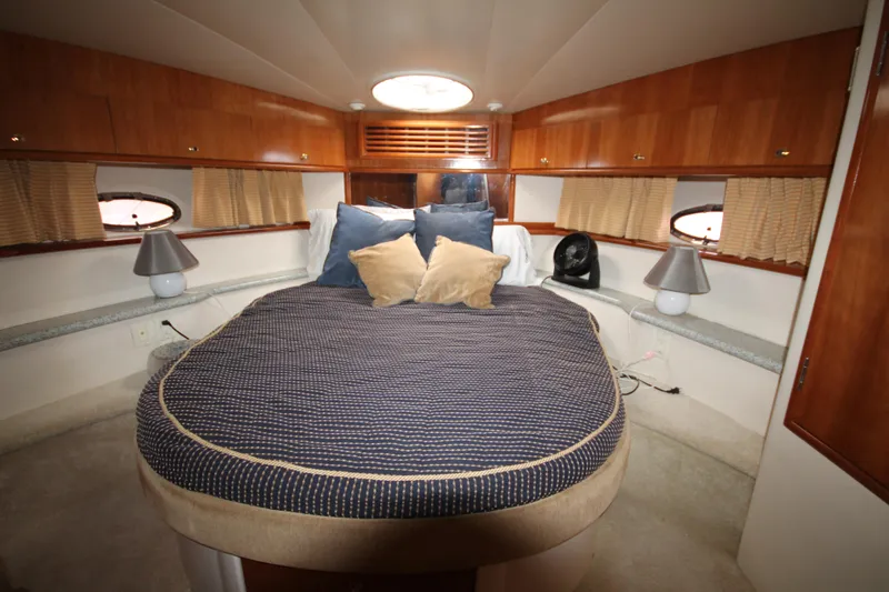 Slide: The Image of 2001 Carver 466 Motor Yacht bedroom with cozy bed and wooden cabinetry - 19